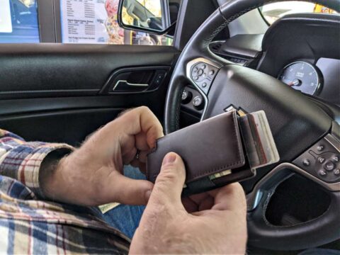 ekster-parliament-wallet-in-car My left hand is showing where the button is to fan the credit cards out of the wallet. It's the coolest feature about Ekster wallets!