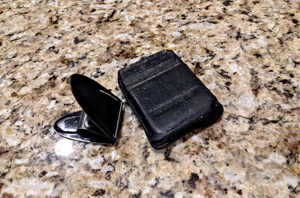 This is the money clamp itself and the leather card holder with several pockets -- both are showing signs of wear.